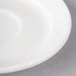 A close-up of a white Villeroy & Boch porcelain saucer with a small hole in the center.