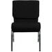 A black church chair with silver legs.