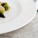 A Villeroy & Boch white porcelain plate with food on it.