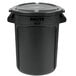 A black Rubbermaid BRUTE round trash can with a lid.