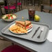 A Carlisle fast food tray with a sandwich and chips on it.