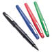 A close-up of a green and red Paper Mate Flair pen with other pens in the background.