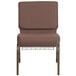 A brown church chair with a metal frame and white dots.