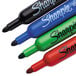 A Sharpie 4-color flip chart marker set with a black bottle and blue cap.