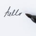 The black tip of a Sharpie Pro Fine Point Industrial Permanent Marker writing on a white surface.