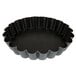 A black round Matfer Bourgeat fluted tart pan.