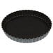 A black Matfer Bourgeat fluted quiche pan with a black rim.