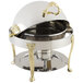 A Bon Chef stainless steel chafer with brass accents and a gold handle.