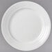 A close-up of a Libbey Galileo Lunar Bright white porcelain plate with a circular design.