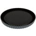 A black Matfer Bourgeat fluted tart pan with a raised bottom.