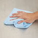 a hand holding a blue towel