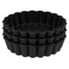 A stack of black fluted tartlet molds.