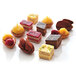 A group of small desserts including tarts, quiches, and pastries.