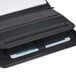 A black leather zippered pad holder with a white sheet of paper inside.