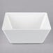 A white square Vollrath melamine bowl with a lid.