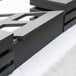 A black rectangular Vollrath wood crossbar.
