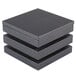 A stack of three Vollrath black wooden cube risers.