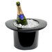 A bottle of wine in a black top hat wine bucket.