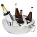A silver metal container with several bottles of wine in it.