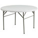 A Flash Furniture white round plastic folding table with metal legs.