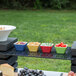 A group of Vollrath melamine display platters with food on a table.