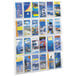 A Safco clear plastic wall mount display rack with 24 compartments holding cards.