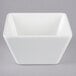 A white square Vollrath melamine bowl.