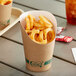 A Kraft paper cup filled with curly fries.