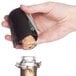 A hand using the Franmara Champagne Combo Opener to open a bottle with a cork.