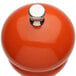 A Chef Specialties butternut orange pepper mill with a silver top.