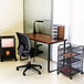 A cherry and black Safco steel workstation desk with a chair next to it.