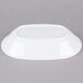 An American Metalcraft white melamine serving bowl on a gray surface.