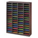 A Safco mahogany wood organizer with many sections holding colorful papers.