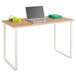 A laptop on a Safco beech and white steel workstation desk.