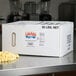 A white box of LouAna coconut oil on a counter.