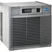 A grey rectangular Follett air cooled ice machine with a vent on top.