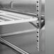 A stainless steel shelf in a Beverage-Air worktop refrigerator.