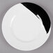 A close-up of a GET Bold white melamine plate with a black and white wide rim.