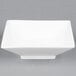 A close-up of a CAC Citysquare bright white square porcelain bowl.