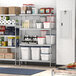 A Regency stainless steel wire shelving kit in a kitchen with food items on the shelves.