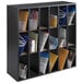A black wood mail sorter with many different sections on a black shelf.