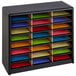 A black shelf with many colored papers in Safco 24 Compartment File Organizer.