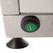 A Doyon countertop dough sheeter with green buttons on a metal surface.