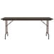 A walnut rectangular Correll folding table with a metal frame.