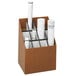 A Safco woodgrain roll file with 12 compartments holding rolls of paper.