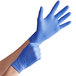 a pair of hands wearing blue gloves