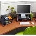 A black Safco steel mesh telephone stand on a desk with a computer and phone.