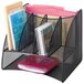 A black wire mesh Safco corner desk organizer with several different items in it.