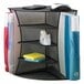 A black Safco mesh corner desk organizer with office supplies inside.