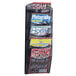 A black Safco Onyx mesh wall mount magazine display rack holding several magazines.